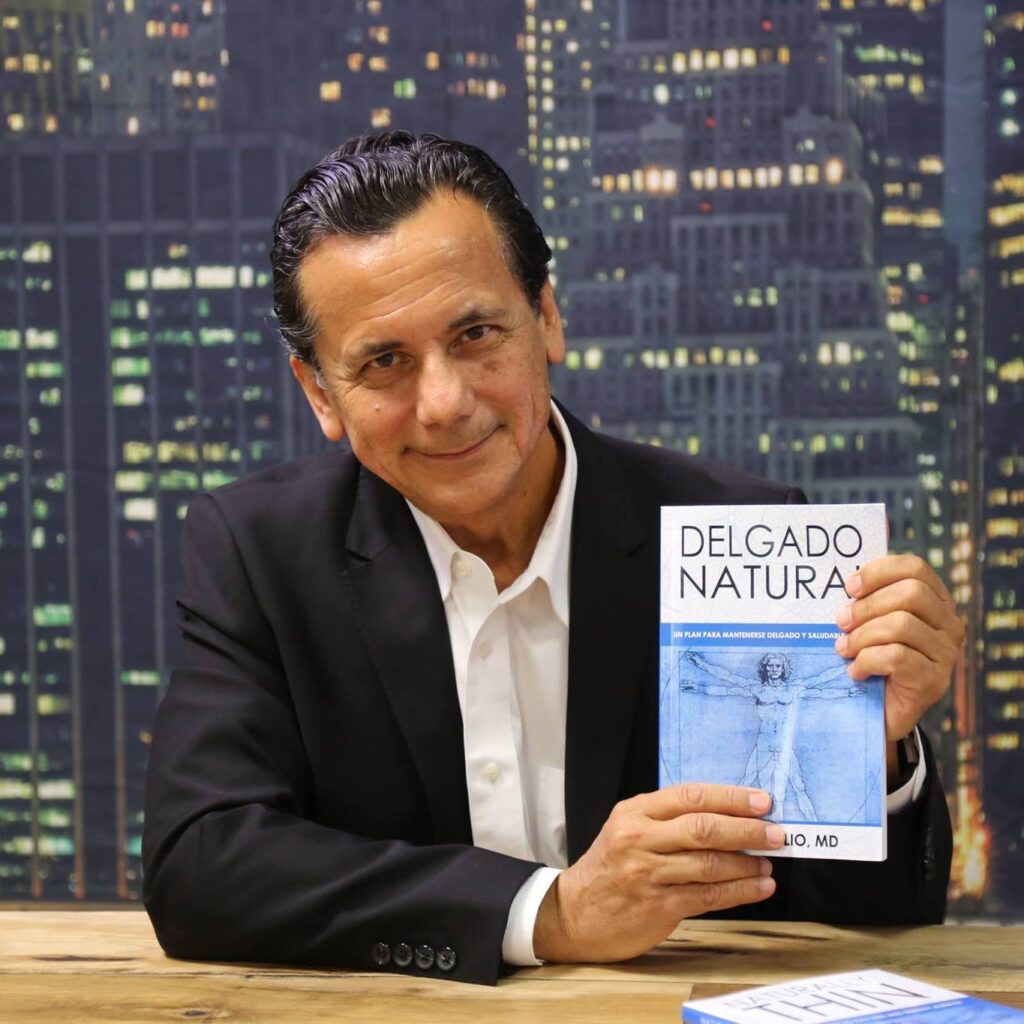 A man holding a book in front of a city skyline.