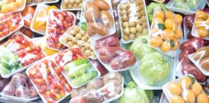 A bunch of different fruits and vegetables in plastic containers
